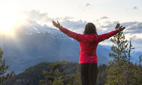 Rear view of person standing against mountain range