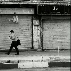 Full length of woman standing against wall