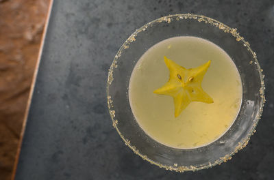 High angle view of starfruit in martini glass on table