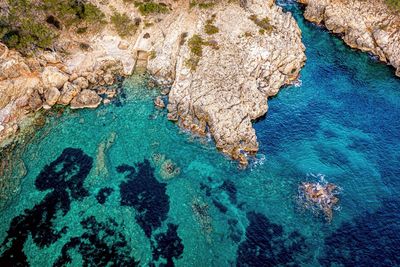 High angle view of rock formation in sea