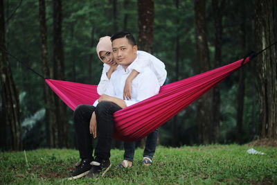 Man holding umbrella in forest