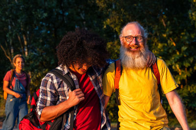 Portrait of senior couple standing against trees