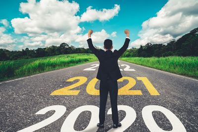 Man standing on road against sky