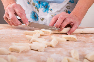 Midsection of man preparing food on table