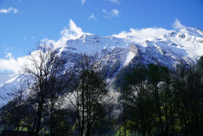 Low angle view of snowcapped mountains against sky