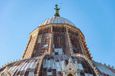 Low angle view of statue of building against blue sky