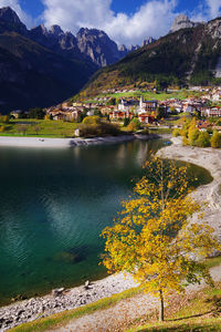 Scenic view of lake by mountains against sky