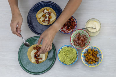 Woman serving mexican tacos high angle view