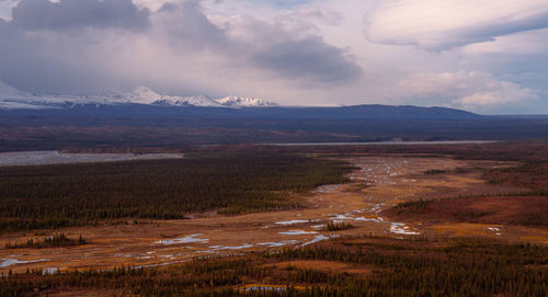 Scenic view of mountains against cloudy sky