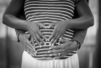 Midsection of pregnant woman with husband