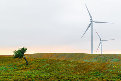 Windmill on field against sky