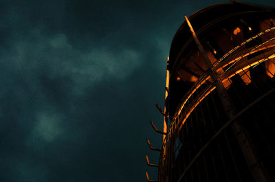 Low angle view of illuminated building against sky at night