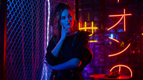 Portrait of young woman standing in factory