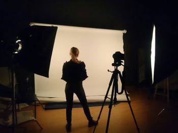 Full length of woman standing by railing