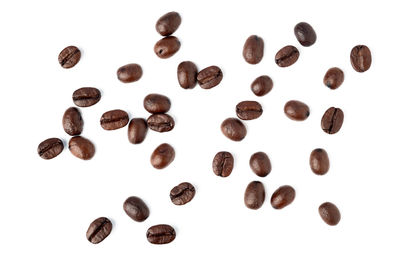 High angle view of coffee beans against white background