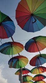 Low angle view of umbrellas against sky