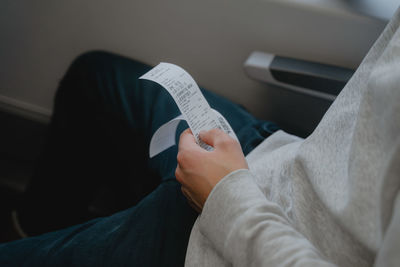 Midsection of woman reading book