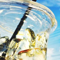 Close-up of beer in glass against sky