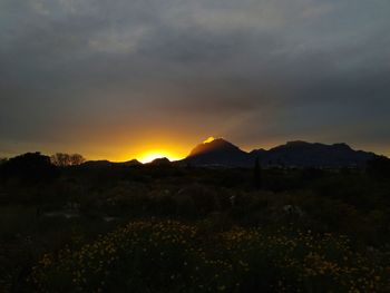 Scenic view of silhouette mountains against sky during sunset