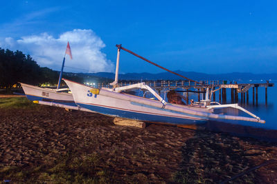 Panoramic view of boats in sea against blue sky