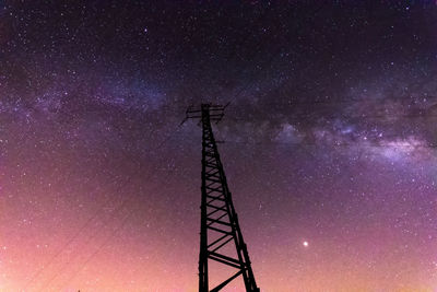 Low angle view of tower against sky at night