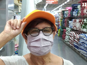 Close-up portrait of man holding eyeglasses