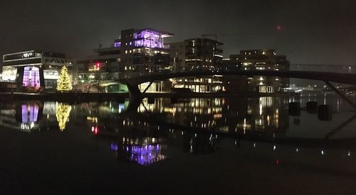 Reflection of buildings in water at night