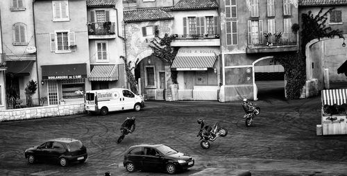 High angle view of people practicing stunts on motorcycle at street