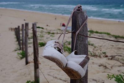 Close-up of wooden post on beach