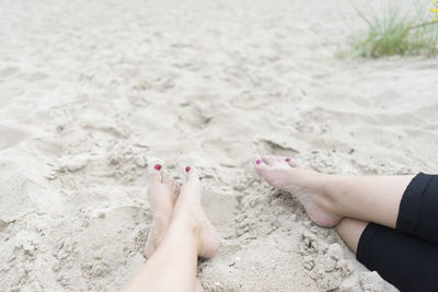 Low section of woman legs on beach