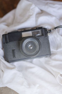 High angle view of camera on bed