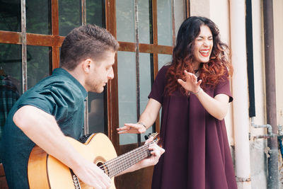 Young couple playing guitar