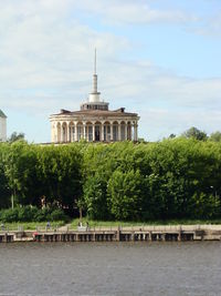 Built structure by lake against sky