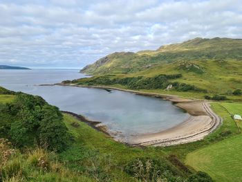 Scenic view of sea and mountains against sky