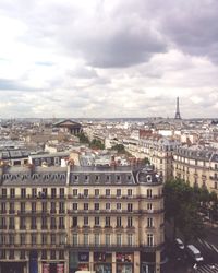 Cityscape against cloudy sky