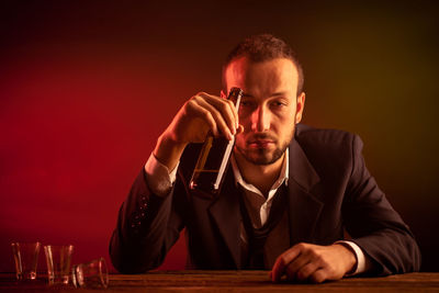 Portrait of young man sitting on table