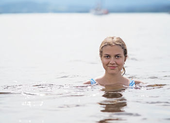 Portrait of a smiling young woman in sea