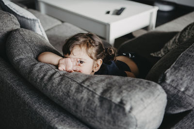 Portrait of cute boy relaxing on sofa at home
