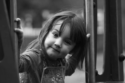 Portrait of cute girl at entrance of bus