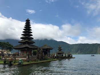 Temple by building against sky