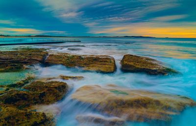 Scenic view of sea against sky at sunset