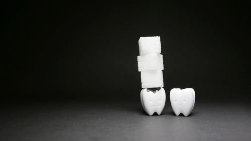 Close-up of stuffed toy on table against black background