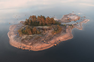 Uninhabited small rocky island illuminated by the setting sun