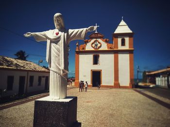 Statue against building and sky