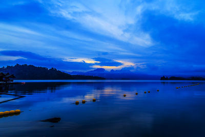 Scenic view of lake against sky at dusk