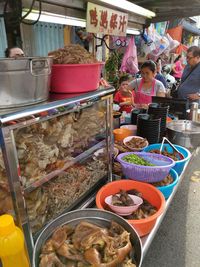 People for sale at market stall