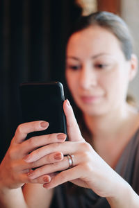 Midsection of woman using mobile phone