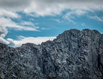 Low angle view of mountain against cloudy sky