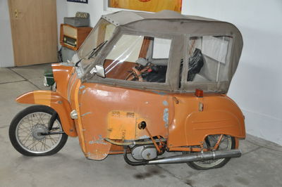 Vintage car on road against wall