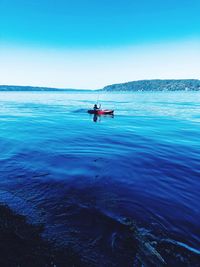 Man on boat in sea against sky
